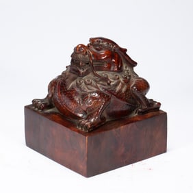A CARVED ANATTO-WOOD BEAST SEAL