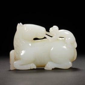 A CARVED WHITE JADE MONKEY ON HORSE