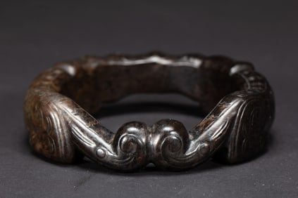 A CARVED JADE BANGLE