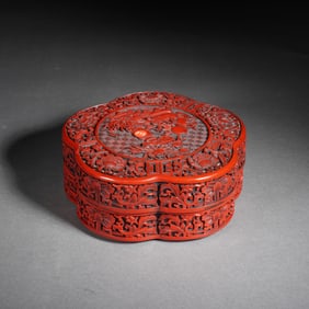 A CARVED CINNABAR LACQUER BOX WITH COVER