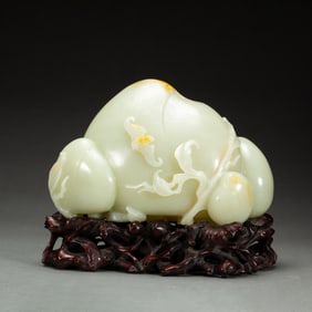 A CARVED WHITE JADE PEACH DECORATION