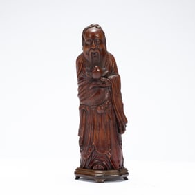 A CARVED BAMBOO STANDING FIGURE