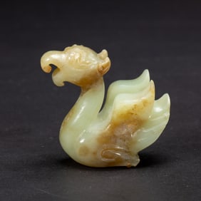A CARVED WHITE JADE MYTHICAL BIRD