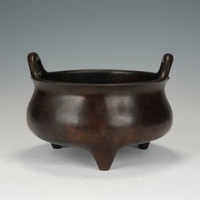 A BRONZE TRIPOD CENSER