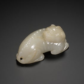 A CARVED WHITE JADE TIGER