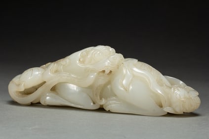 A CARVED WHITE JADE MYTHICAL BEAST