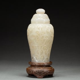 A CARVED WHITE JADE VASE WITH COVER