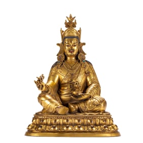 A BRONZE-GILT FIGURE OF PADMASAMBHAVA