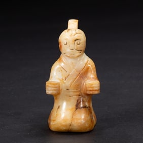A CARVED JADE KNEELING FIGURE