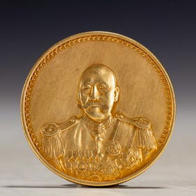 A SILVER-GILT COIN