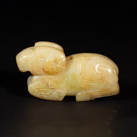 A CARVED WHITE JADE RAM