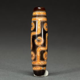 A RARE TIBETAN DZI BEAD