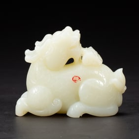 A CARVED WHITE JADE MYTHICAL BEAST QILIN