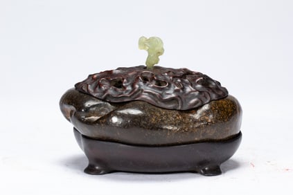 A CARVED STONE BOX WITH COVER