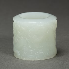 A CARVED WHITE JADE ARCHER RING