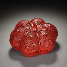 A CARVED CINNABAR LACQUER BOX WITH COVER