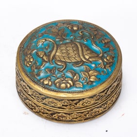 AN ENAMLED BRONZE-GILT BOX WITH COVER