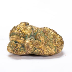 A BRONZE-GILT BEAST
