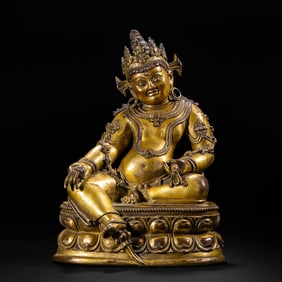 A BRONZE-GILT FIGURE OF JAMBHALA