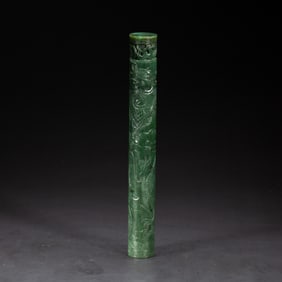 A CARVED SPINACH GREEN JADE PENDANT