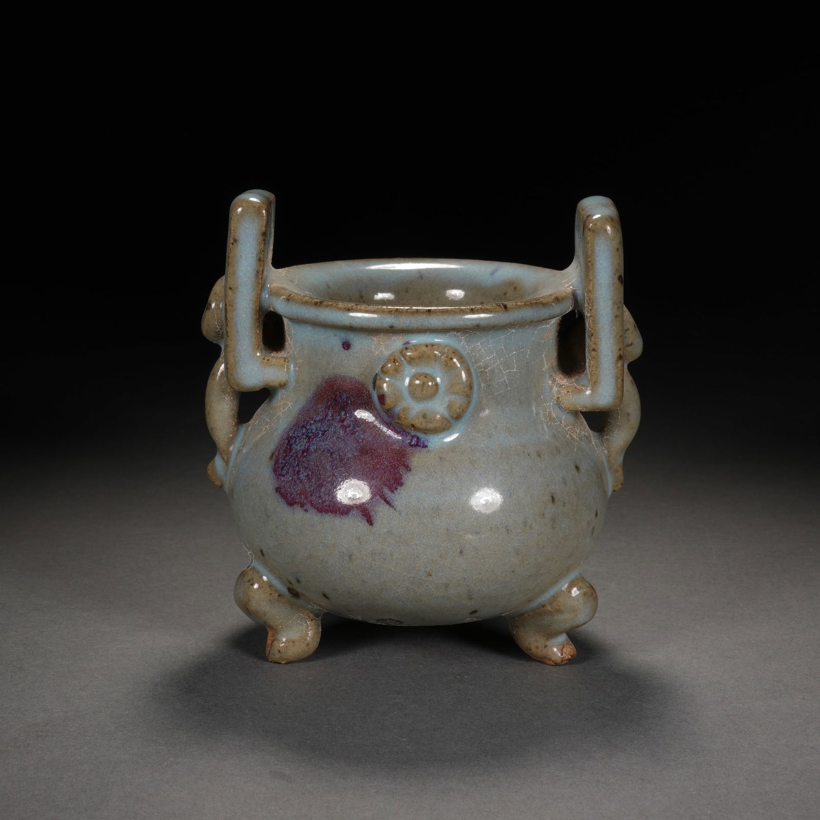 A JUN-WARE TRIPOD CENSER: A JUN-WARE TRIPOD CENSER Of compressed form, the censer is raised on three short, curved feet and applied with two upright loop handles on the rim. DIMENSIONS: 11x10x11.5 cm. HAVE A SIMILAR ITEM TO SE