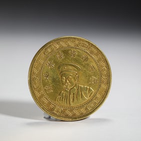 A CHINESE SILVER-GILT COIN