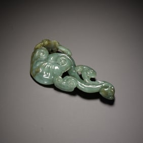 A CARVED CELADON JADE LINGZHI PENDANT