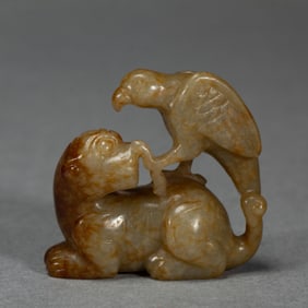 A JADE CARVING OF FALCON ON BEAR