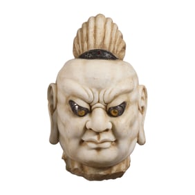 A IMPRESSIVE CARVED MARBLE HEAD OF GUARDIAN KING