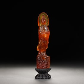 A CARVED AMBER STANDING GUANYIN