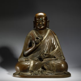 A HARDSTONE INLAID BRONZE SEATED MASTER