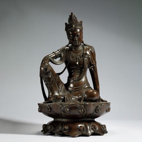 A CARVED ANNATTO WOOD GUANYIN