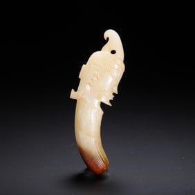 A JADE CARVING OF MYTHICAL HEAD