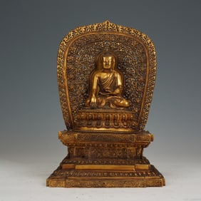 A RARE BRONZE-GILT FIGURE OF SHAKYAMUNI