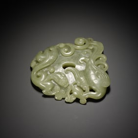 A CARVED CELADON JADE CHILONG ARCHER RING SHE