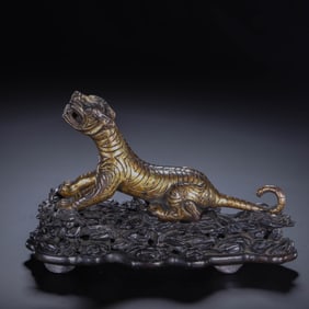 A BRONZE PARTLY GILT TIGER