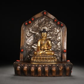 A SILVER PARTLY GILT SEATED SHAKYAMUNI