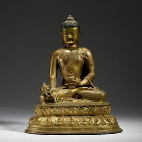 A BRONZE-GILT SEATED MEDICINE BUDDHA