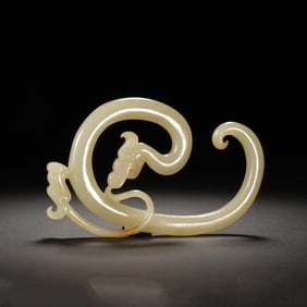 A CARVED WHITE JADE DRAGON