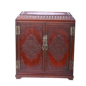 A CARVED HUANGHUALI CABINET