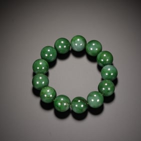 A SPINACH GREEN JADE BRACELET
