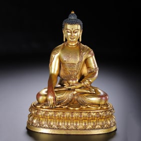 A BRONZE-GILT FIGURE OF SHAKYAMUNI