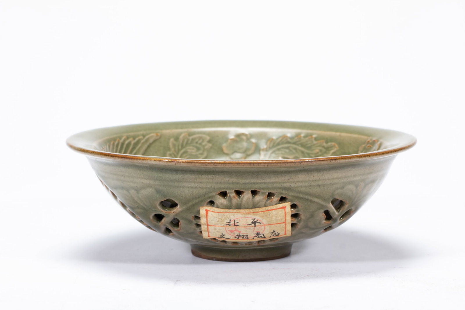 A LONGQUAN CELADON GLAZE BOWL: A LONGQUAN CELADON GLAZE BOWL The deep rounded sides rising from a slightly tapered foot to an everted rim, incised with flying phoenix at the interior, applied with olive green glaze. DIMENSIONS: L. 