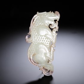 A CARVED WHITE JADE MYTHICAL BEAST