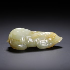 A CARVED WHITE JADE MYTHICAL BEAST