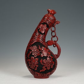 A CARVED CINNABAR LACQUER EWER
