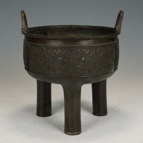 A BRONZE TRIPOD CENSER