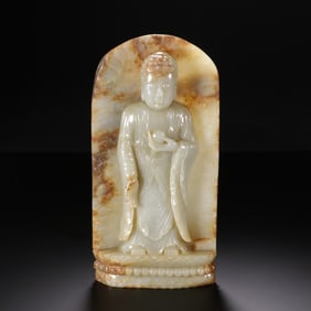 A CARVED WHITE JADE STANDING BUDDHA