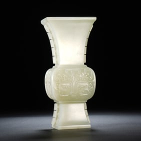 A CHINESE ARCHAISTIC CARVED WHITE JADE BEAKER VASE GU