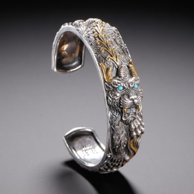 A SILVER PARTLY GILT BANGLE